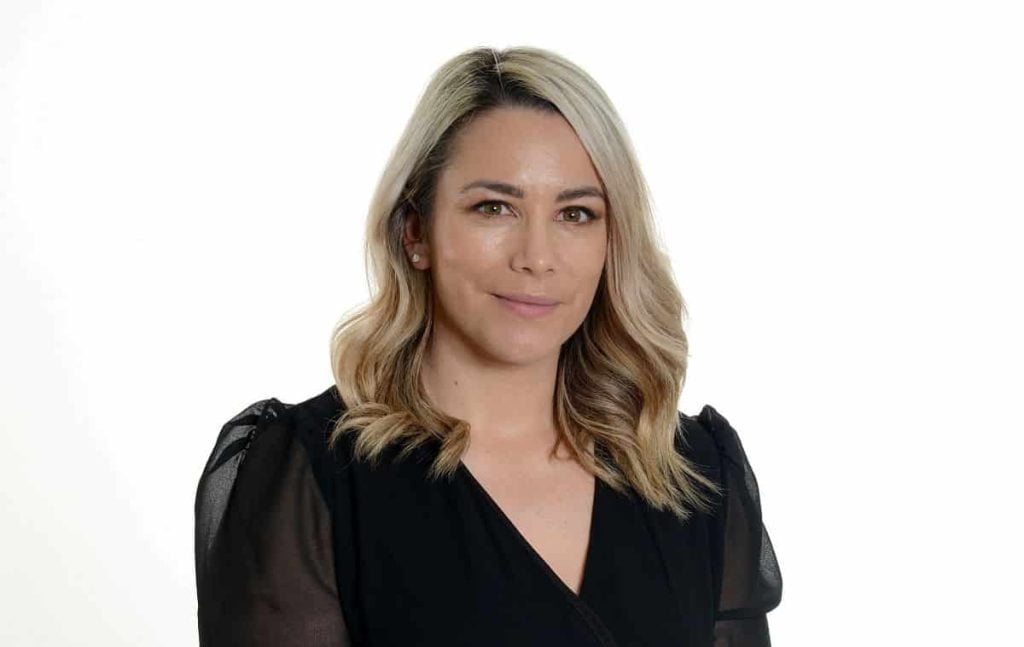Karla Thomas, Marketing Manager at Playdale Playgrounds Ltd is wearing a black v-neck blouse and has blonde hair