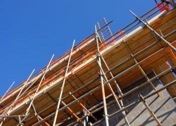 Scaffolding at a construction site under blue sky.