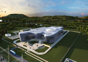Modern research facility surrounded by greenery and landscape.