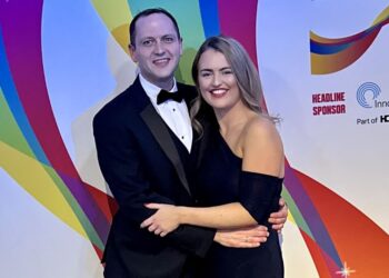 Couple at colourful Care Awards event.