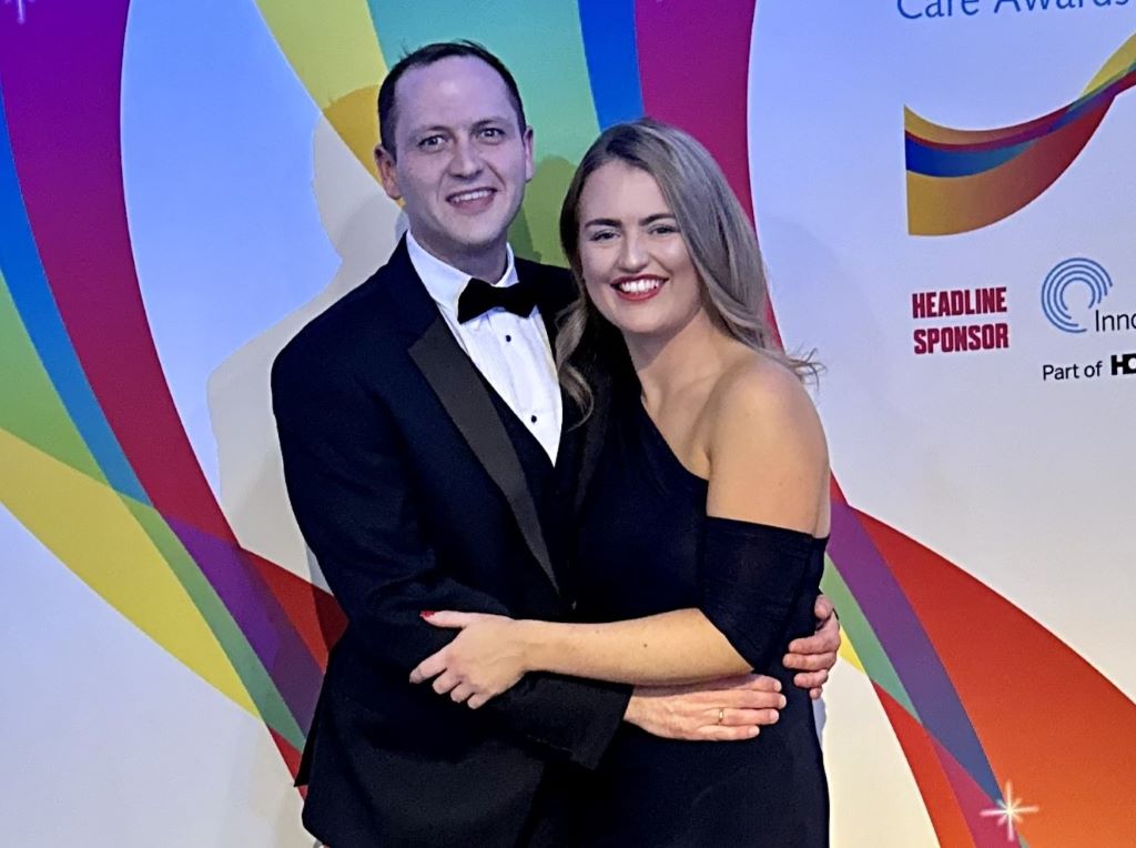 Couple at colourful Care Awards event.
