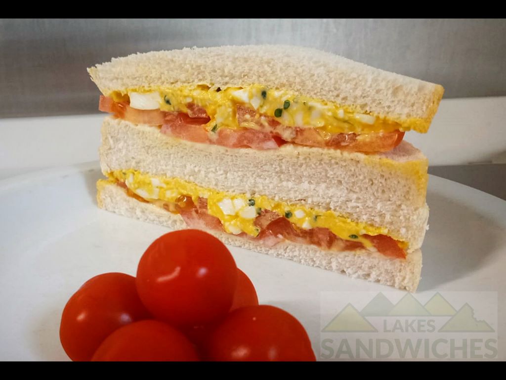 Egg and tomato sandwich with cherry tomatoes.
