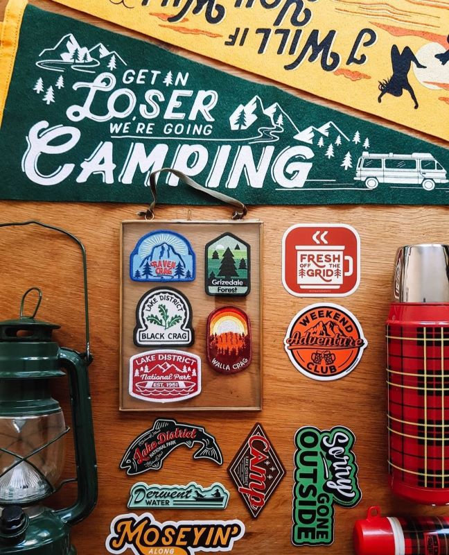 Camping gear and adventure-themed stickers and patches display.