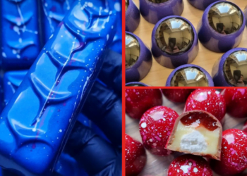 Assorted gourmet chocolates with decorative coloured designs.