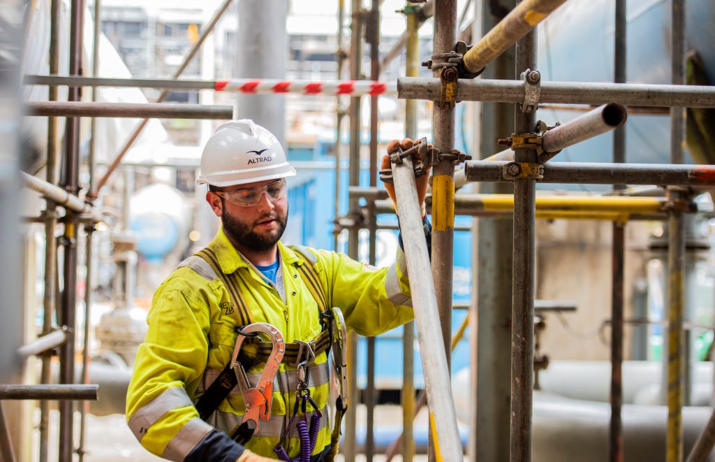 Construction worker assembling scaffolding