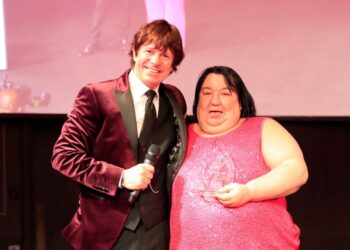 Two people at an awards ceremony.