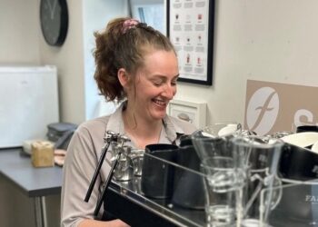 Barista smiling while making coffee
