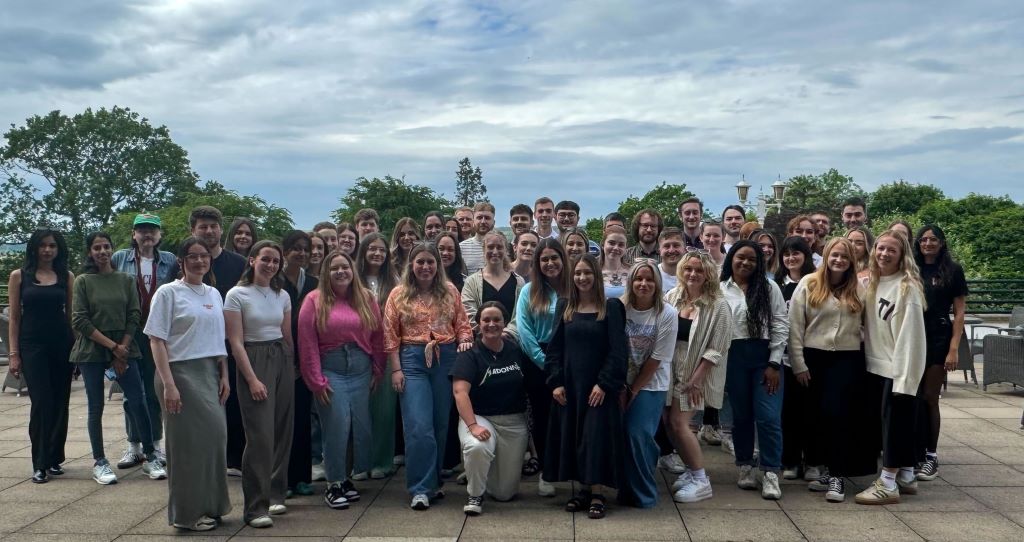 Group photo of people outdoors.