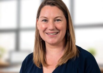 Smiling woman in professional setting.