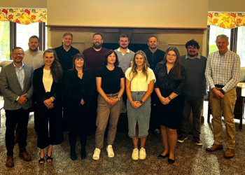 Group photo of twelve people indoors.