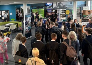 Students and exhibitors at a career fair event.