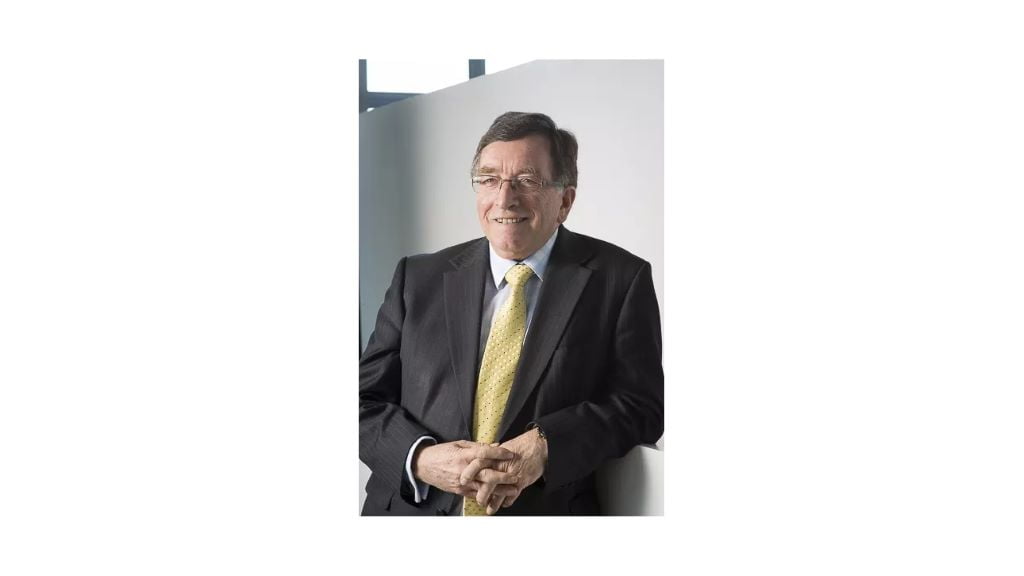 Man in suit with yellow tie smiling