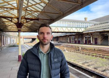 Man at an empty train station platform.