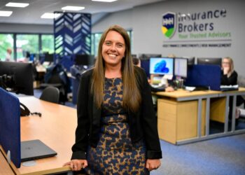 Woman in office at insurance brokerage.