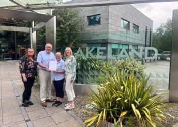 Four people standing with certificate at Lakeland store.