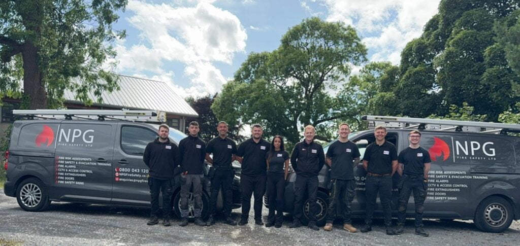 NPG Fire Safety staff standing in front of vans.
