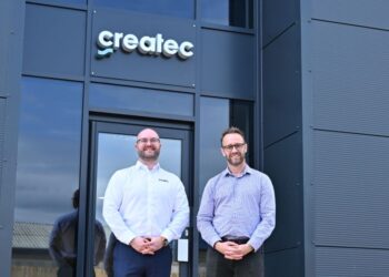 Two men standing in front of Createc building