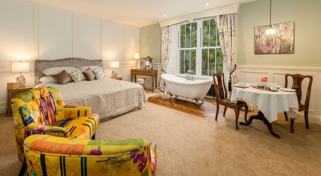 Cosy bedroom with a free-standing bathtub.