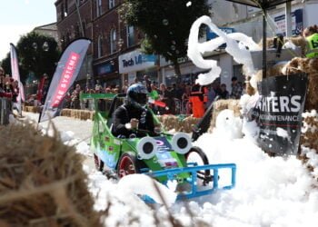Soapbox race driver navigates foam-covered track