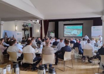 People attending a presentation in a hall.