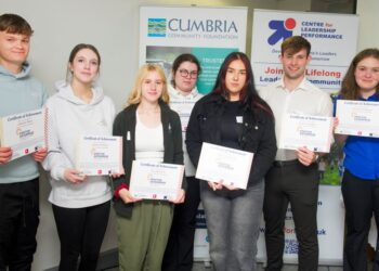 Group of students holding certificates of achievement.