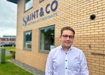 Man standing in front of Saint & Co building.