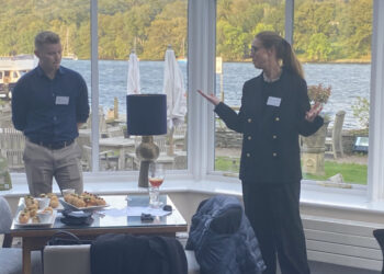 Business discussion in a lakeside restaurant.