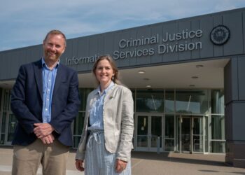 Two people outside Criminal Justice Services Division.