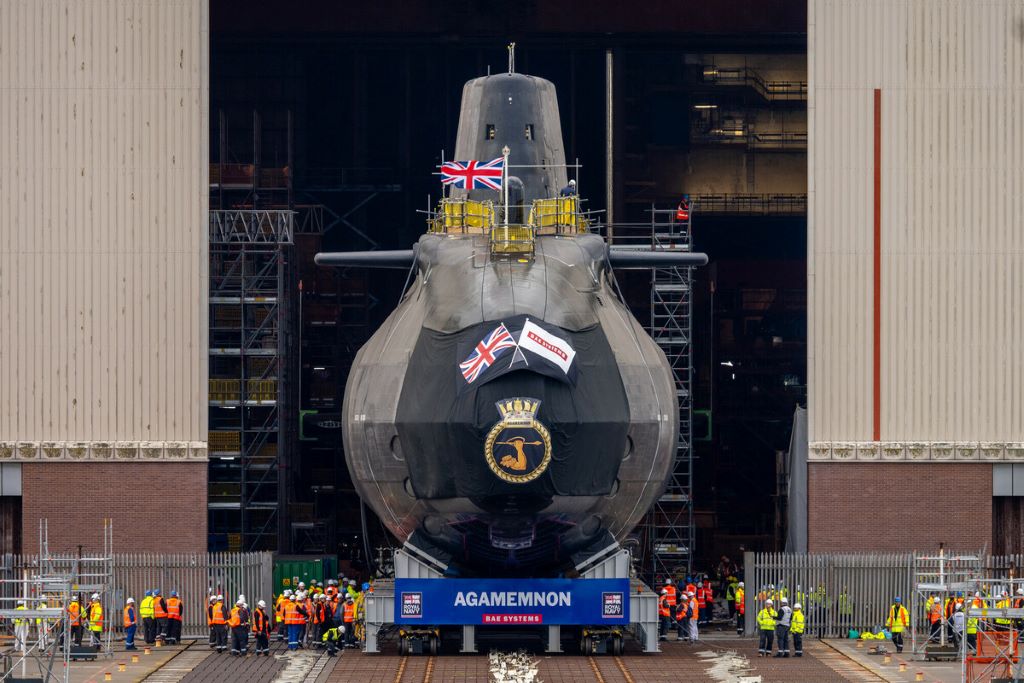 Submarine Agamemnon in shipyard with workers around.