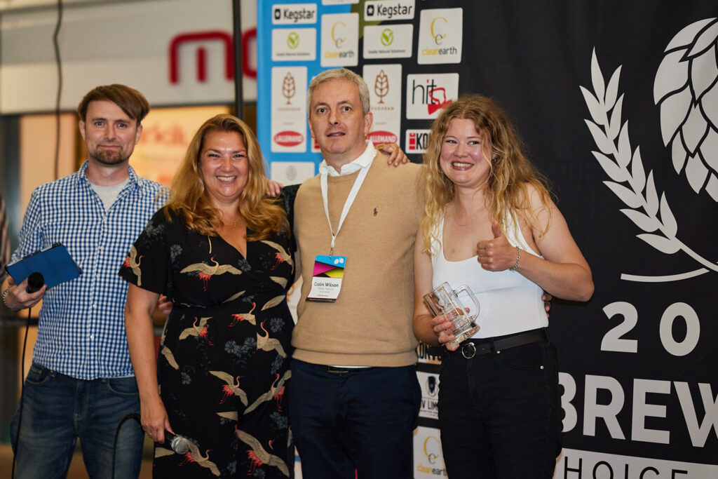 Four people smiling at a brewery event
