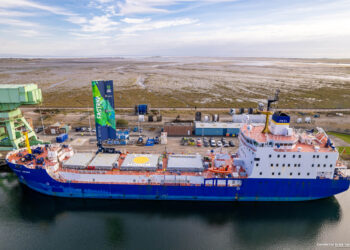 Blue cargo ship at industrial dock