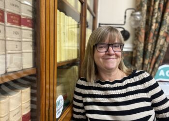 Woman in library with law books.