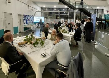 Formal dinner event with guests and staff in hall.
