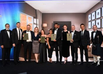 Award winners group photo at formal event.