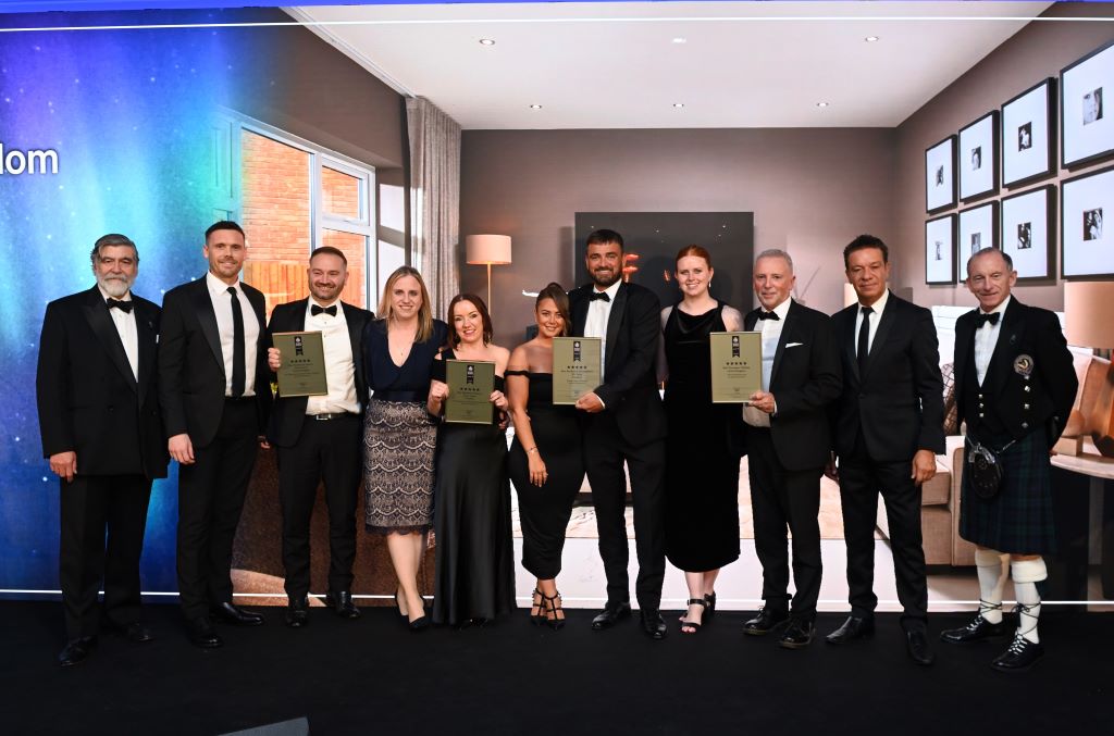 Award winners group photo at formal event.