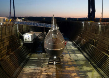 Submarine in dry dock during sunset