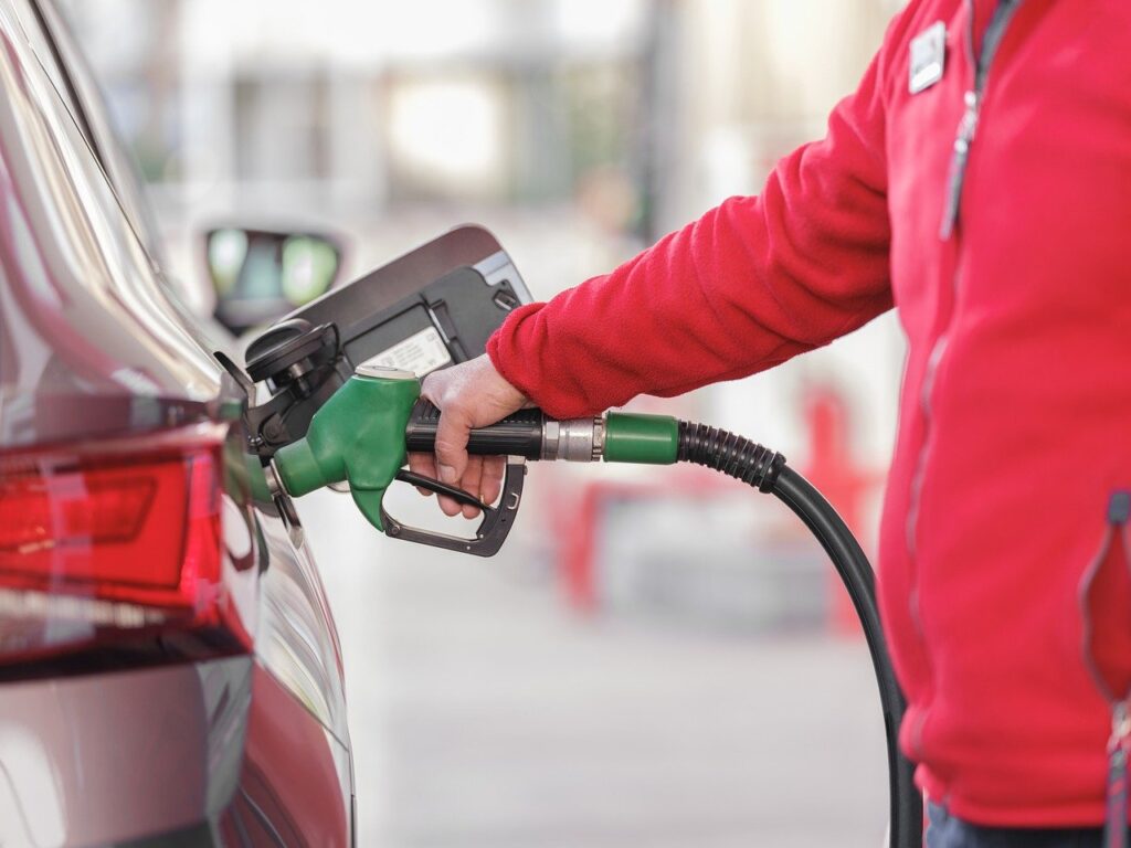 Person refuels car at petrol station