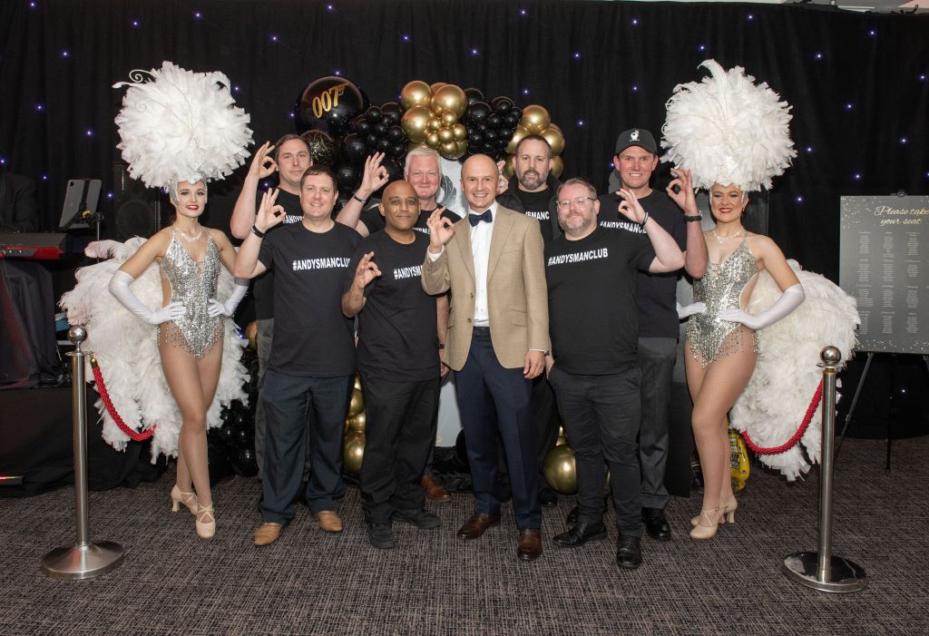 Group of people smiling at themed event.