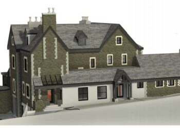 Historic stone building with steep slate roof.