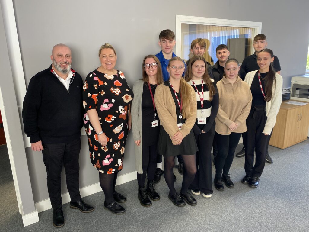 Group of professionals posing in office setting.
