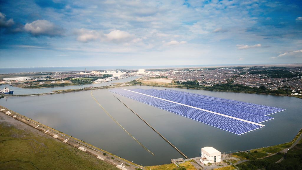 Floating solar panels on reservoir near industrial area.