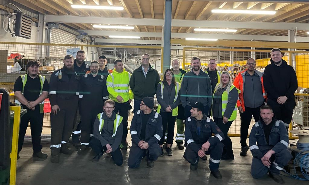 Group of warehouse workers posing for a photo.
