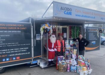 Sara Oldham from Cash for Kids (centre) with Alcedo's Adam Garvey (right) and Santa (left)