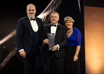 JLR UK managing director Patrick McGillycuddy and Lloyd Land Rover's head of business Stephen Trickett with his award with host, Clare Balding