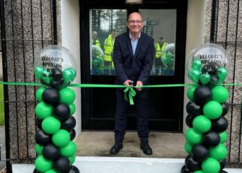 Mark Ritchie cutting the ribbon to open the new premises.